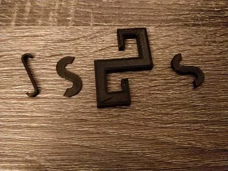 Photo of four double-sided hooks; from left to right, different designs are used. The first is long with small hooks at the end; the second is fat and flat like an S shape; the third incorporates square design for the hook ends instead of curves; the last one looks like the second.
