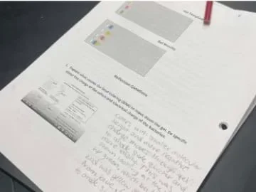 A photo of a student filling out a lab report.