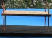 Photo shows two horizontal surfaces connected by corner sticks.