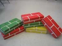 Photo of six shoe-box sized cardboard classroom building blocks.