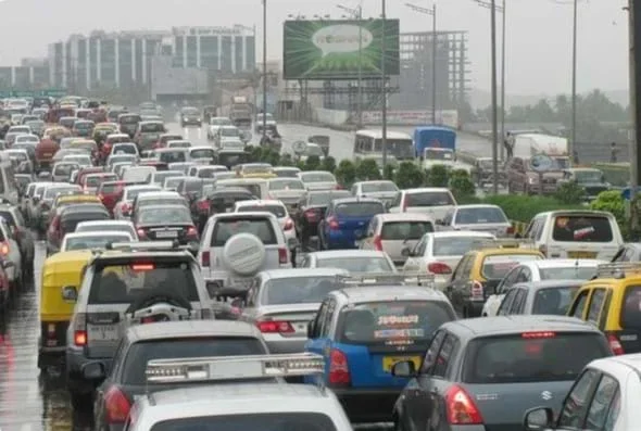 A photo of an urban highway traffic jam with cars, trucks, and buses.