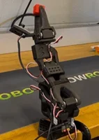 A photo showing the SO-101 AI Robot holding the red cube with end effector (grippers).