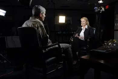 A photograph shows two people talking, face-to-face in a dark TV studio. This was a sit-down interview with Air Force Chief of Staff Gen. Norton Shwartz by Lara Logan for 60 Minutes on April 15, 2009.
