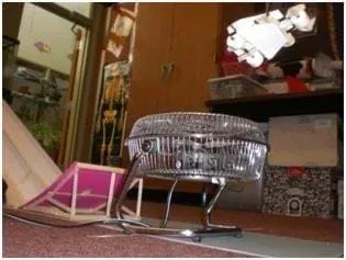 Photo shows a car being jumped off a small ramp and being blown by a fan pushing air up onto the bottom of the car.