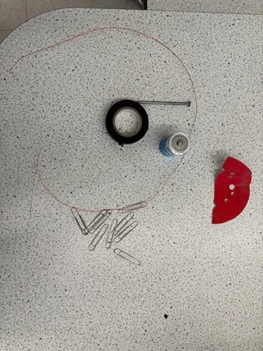 Materials for building an electromagnet include a D-cell battery, 24” of insulated thin copper wire, electrical tape, 4” uncoated steel nail, and small piece of sandpaper.