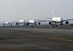 A photo shows several airplanes taxiing on the runway at Dubai International Airport in Dubai, United Arab Emirates.