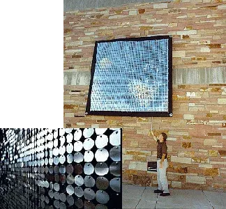 View of the shiny wall sculpture from a distance, and up close, to see the discs.