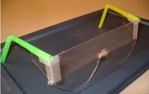 Photo shows rudimentary glasses made with clear cut plastic for lenses, bent straws for temples and tape.