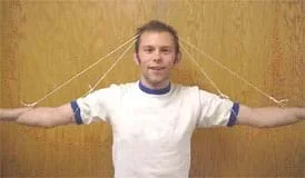 Photo shows two pieces of string tied to the arms and elbows of a person and stretched over the top of their head forming two A shapes.