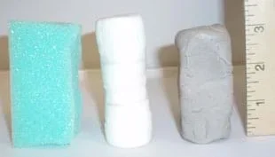 Photo shows columns of foam, marshmallows and clay lined up by a ruler, so you can see their 3-inch heights.