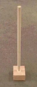 Photo shows a dowel rod attached vertically to the middle of a wooden block.