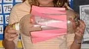 A photograph shows a horizontal two-liter bottle with paper paddles taped around the middle section.