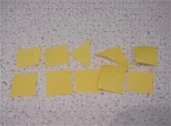 A photograph of 10 yellow pieces of construction paper, representing chips.