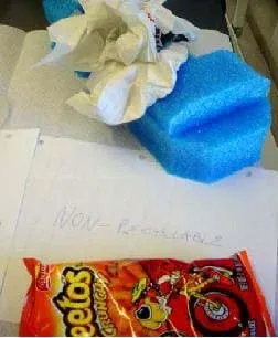 Photo shows packing foam, snack chip bag, and paper towels.