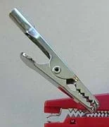 Photo shows a silver device with a hinged jaw and jagged teeth.