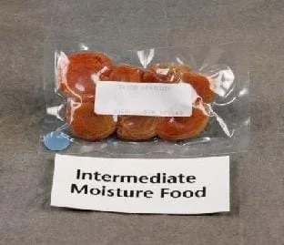 Seven flat orange apricots encased in plastic. A small sign below the bag reads: "Intermediate Moisture Food."