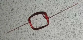 A photo shows red, magnet wire coiled into the shape of a rectangle.