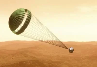 An illustration of the opened parachute connected to the backshell.