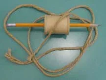 Photo of wooden spool, pencil and string.