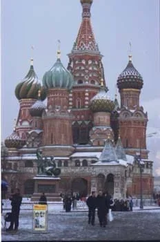 Photo of red brick towers with colorful onion-shaped domes.