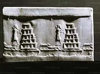 Photo of a stone with images of people, animals and stacked pyramids.