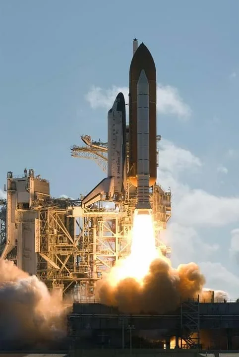Photo shows a US space shuttle lifting off with much fire and smoke seen below the rocket.