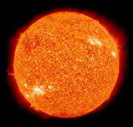 Photo shows the sun with solar flares erupting from the surface.