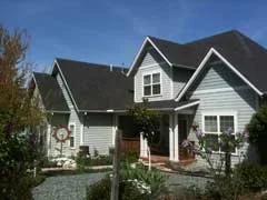 A photo shows the front of a house with four peaked rooflines.