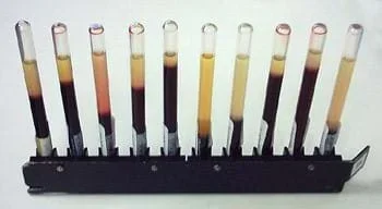 A photograph shows 10 round-style glass tubes lined up in a rack. Each tube with murky liquids inside shows a different sedimentation rate. The fifth tube from the left is the disease-free normal blood. The ESR value deviates from the normal value if a disease is present.
