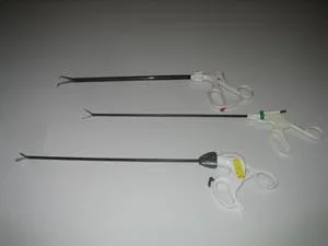 Three grasping devices with handles that look like scissors handles.