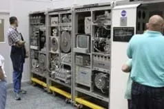 A photo showing visitors viewing a water recovery system like the one used on the ISS that is on display at the Marshall Space Flight Center.