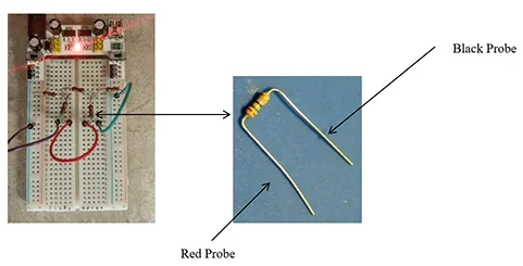Two photograph. A breadboard with numerous wires and resistors. A close-up of a resistor with labels indicating which end connects to the black probe and which to the red probe.