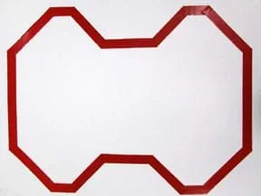 A photograph shows a continuous loop of red reflective tape on a 24 x 36-inch piece of white poster board. The route includes a series of straight sections with periodic left and right turns, none greater than 45°.