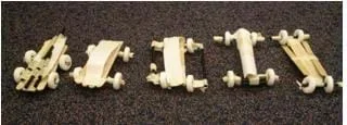 Photo shows five cars made of Popsicle-sticks, masking tape, straws, and Lifesaver ® mint candies (wheels).