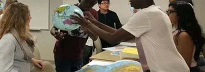 A photograph shows teens around a table, one holding a plastic inflated Earth globe while other students determine how the Coriolis effect occurs in the Northern and Southern Hemispheres.