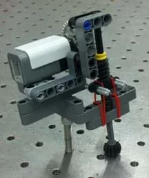 Photo shows a pressure sensor comprised of a rotation sensor, rubber bands, and other LEGO pieces.