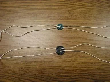 Photo shows two different-sized threaded buttons with different moments of inertia.
