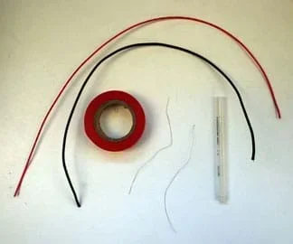 A photograph shows two 20-cm lengths of insulated wire, a roll of electrical tape, a plastic pen barrel and two 10-cm lengths of non-insulated nichrome wire.
