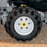 Photo shows a toy wheel made from a flexible black treaded plastic tire and a hard grey plastic rim.