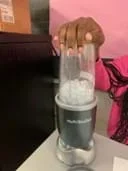 A photo showing a student blending the strips of paper into the paper pulp using a nutribullet blender.