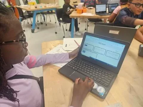 A photo showing a student working on a laptop.
