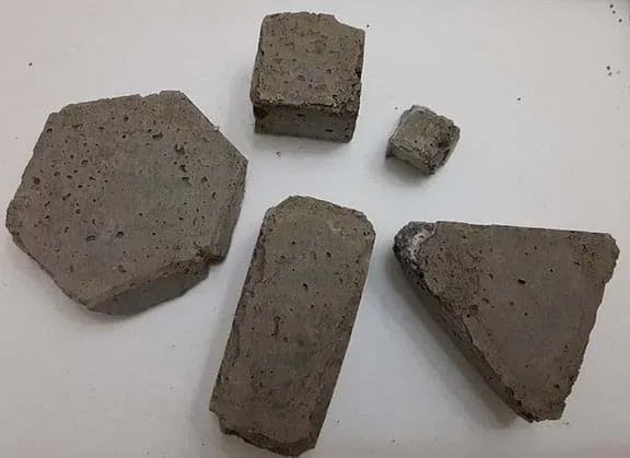 Five resin block prototypes of different sizes and shapes set against a white background.