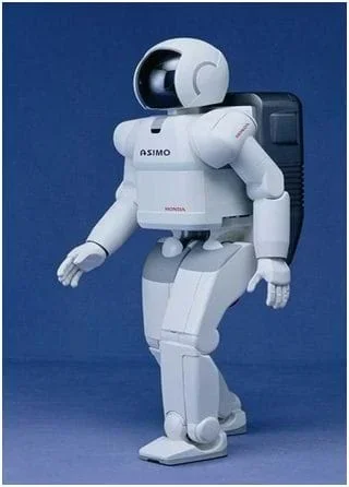 Photo shows a bi-pedal robot that looks like a person in a spacesuit and helmet.