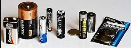 A photograph showing commonly used batteries of various styles and supplying voltage.
