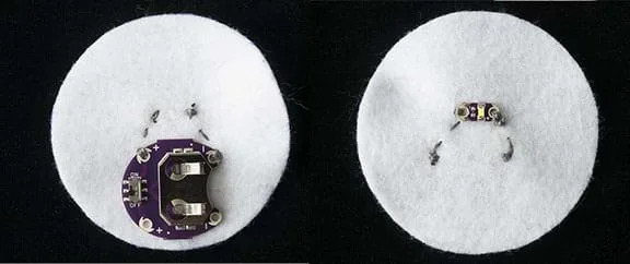 A photograph shows the back and front of a three-inch round white felt circle after a battery holder and an LED board are sewed down on opposite sides using conductive thread.
