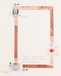 A photograph shows a completed paper circuit on a cardstock template. It looks like a rectangle composed of copper tape (a circuit), a battery, an LED and a LilyPad button.