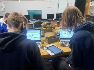 Two students are uploading their App Inventor files onto an Android tablet.