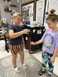 A photo showing one student who just dropped the ruler and another student catching it between their thumb and first finger.