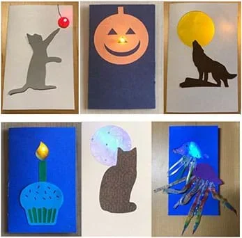Photographs of different cards include: 1) gray cat cutout standing on hind legs with a paw batting at ball held up by a string (with an LED in the ball) in the upper right hand corner; 2) a howling wolf cutout in front of a yellow moon made by cutting out a big circle in the cardstock that is then covered in yellow tissue paper; 3) a cat shape cut out of brown patterned paper that is partially covering a circle moon shape that is covered with white sparkly tissue paper;