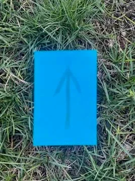 A photo showing a prototype of a simulated cyanotype print on construction paper.